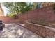 Paver patio and brick retaining wall in backyard with ambient string lights at 6714 Flamenco Ct, Las Vegas, NV 89139