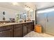 Bathroom with dual vanity, granite counters, and walk-in glass shower at 6714 Flamenco Ct, Las Vegas, NV 89139