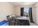 Bedroom with a large window and black curtains, offering natural light and privacy, complemented by neutral wall color at 6714 Flamenco Ct, Las Vegas, NV 89139