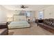 Comfortable bedroom features large windows, carpeted floors, and a plush bed and seating area at 6714 Flamenco Ct, Las Vegas, NV 89139