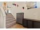 Entryway featuring carpeted stairs, wall decor, and storage cabinets creating an organized and inviting space at 6714 Flamenco Ct, Las Vegas, NV 89139