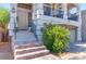 Welcoming front entrance with a stylish door, tiled steps, and manicured greenery at 6714 Flamenco Ct, Las Vegas, NV 89139