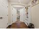 Hallway featuring wood-look flooring, white shelving, and a view into a bedroom through double doors at 6714 Flamenco Ct, Las Vegas, NV 89139