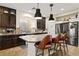 Stylish kitchen featuring dark wood cabinets, granite countertops, and stainless steel appliances at 6714 Flamenco Ct, Las Vegas, NV 89139