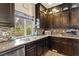Close-up of a kitchen area showcasing elegant granite countertops and dark wood cabinetry at 6714 Flamenco Ct, Las Vegas, NV 89139