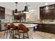 Spacious kitchen with a center island, dark wood cabinets, and sleek countertops at 6714 Flamenco Ct, Las Vegas, NV 89139