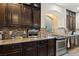 Stylish kitchen featuring granite countertops, stainless steel appliances, and dark wood cabinets at 6714 Flamenco Ct, Las Vegas, NV 89139