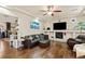 Cozy living room featuring hardwood floors, a fireplace, and comfortable leather seating at 6714 Flamenco Ct, Las Vegas, NV 89139