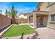 Landscaped backyard features artificial turf, gravel and a covered patio at 6869 Desert Thrasher Dr, North Las Vegas, NV 89084