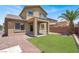 Backyard showing artificial turf, landscaping and covered patio at 6869 Desert Thrasher Dr, North Las Vegas, NV 89084