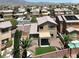 A well-kept backyard featuring desert landscaping, artificial turf, a covered patio, and a refreshing pool at 6869 Desert Thrasher Dr, North Las Vegas, NV 89084