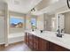 This bathroom offers a dual sink vanity, modern fixtures, large mirrors and a separate bathtub at 6869 Desert Thrasher Dr, North Las Vegas, NV 89084