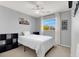 Comfortable bedroom with neutral walls, a ceiling fan, and a window providing natural light at 6869 Desert Thrasher Dr, North Las Vegas, NV 89084
