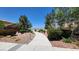 A winding walkway surrounded by lush landscaping, enhancing the community's serene atmosphere at 6869 Desert Thrasher Dr, North Las Vegas, NV 89084
