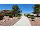 A well maintained sidewalk surrounded by desert landscaping in a residential community at 6869 Desert Thrasher Dr, North Las Vegas, NV 89084