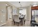 The dining room boasts a chandelier and a dark wood table, set with seating for six people at 6869 Desert Thrasher Dr, North Las Vegas, NV 89084