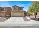 Two-story home with a well maintained front yard and attached two-car garage at 6869 Desert Thrasher Dr, North Las Vegas, NV 89084