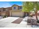 Charming front exterior features a two-car garage, landscaped yard, and inviting curb appeal at 6869 Desert Thrasher Dr, North Las Vegas, NV 89084