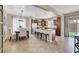 Spacious kitchen with a central island and stool seating that opens up to a dining area with large windows at 6869 Desert Thrasher Dr, North Las Vegas, NV 89084