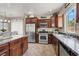 Bright kitchen features stainless steel appliances, dark wood cabinets, and plenty of natural light at 6869 Desert Thrasher Dr, North Las Vegas, NV 89084