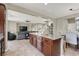 Open concept layout showcases the kitchen island connected to the living area with comfortable seating at 6869 Desert Thrasher Dr, North Las Vegas, NV 89084
