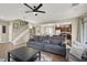Open living space with neutral walls, comfortable seating, and a view of the kitchen and dining area at 6869 Desert Thrasher Dr, North Las Vegas, NV 89084