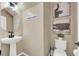 Stylish powder room featuring a pedestal sink, updated lighting, and modern decor at 6869 Desert Thrasher Dr, North Las Vegas, NV 89084