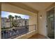 A balcony with views of the building's parking lot, palm trees, and other units at 7155 S Durango Dr # 309, Las Vegas, NV 89113
