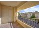 This balcony overlooks the parking lot, featuring a view of the apartment complex, and a door for entry at 7155 S Durango Dr # 309, Las Vegas, NV 89113