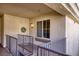 The exterior entryway to the residence features a decorative wreath, neutral colors and a window at 7155 S Durango Dr # 309, Las Vegas, NV 89113