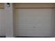A neutral colored garage door is the focal point, set against a textured wall at 7155 S Durango Dr # 309, Las Vegas, NV 89113