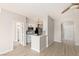 Well-lit kitchen featuring stainless steel appliances, white cabinetry, and an open view of the living area at 7155 S Durango Dr # 309, Las Vegas, NV 89113