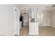 Kitchen featuring stainless steel appliances, white cabinets, and a breakfast bar overlooking the living space at 7155 S Durango Dr # 309, Las Vegas, NV 89113