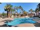 Community pool with palm trees and lounge chairs at 7155 S Durango Dr # 309, Las Vegas, NV 89113
