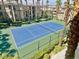 An aerial view of a tennis court surrounded by palm trees at 7155 S Durango Dr # 309, Las Vegas, NV 89113
