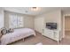 Neutral bedroom with plantation shutters and a sleek TV stand at 75 Archer Glen Ave, Henderson, NV 89002