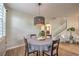 Cozy dining area featuring a modern light fixture and easy access to the living room at 75 Archer Glen Ave, Henderson, NV 89002