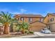 Two-story home with a tile roof, manicured landscaping, and a welcoming driveway at 75 Archer Glen Ave, Henderson, NV 89002