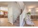 Hallway with staircase and view into the kitchen at 75 Archer Glen Ave, Henderson, NV 89002