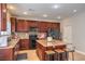 Bright kitchen with stainless steel appliances, island and tile flooring at 75 Archer Glen Ave, Henderson, NV 89002