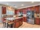 Kitchen with granite countertops, a stainless steel fridge, and custom cabinetry at 75 Archer Glen Ave, Henderson, NV 89002