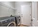 Modern laundry room with gray front load washer and dryer at 75 Archer Glen Ave, Henderson, NV 89002