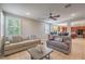 Bright living room with tile flooring, plantation shutters, and views of the backyard at 75 Archer Glen Ave, Henderson, NV 89002
