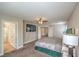 Spacious main bedroom featuring a TV, ceiling fan, and ensuite bathroom at 75 Archer Glen Ave, Henderson, NV 89002