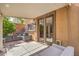 Covered patio features outdoor seating and a view to the home's interior through glass-paneled doors at 75 Archer Glen Ave, Henderson, NV 89002