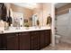 Bathroom featuring a double vanity with sinks, a mirror and a separate shower at 7630 Canyon Diablo Rd, Las Vegas, NV 89179