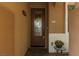 Close up of front door featuring sidelight and decorative pot on small table at 7630 Canyon Diablo Rd, Las Vegas, NV 89179