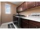 Functional laundry room boasts modern washer/dryer, cabinets, and ample counter space at 7630 Canyon Diablo Rd, Las Vegas, NV 89179