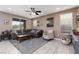 Comfortable living room featuring a ceiling fan, neutral tones, and tile flooring at 7630 Canyon Diablo Rd, Las Vegas, NV 89179