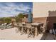 Outdoor patio seating with an umbrella and stone bar, great for outdoor dining and relaxation at 7630 Canyon Diablo Rd, Las Vegas, NV 89179
